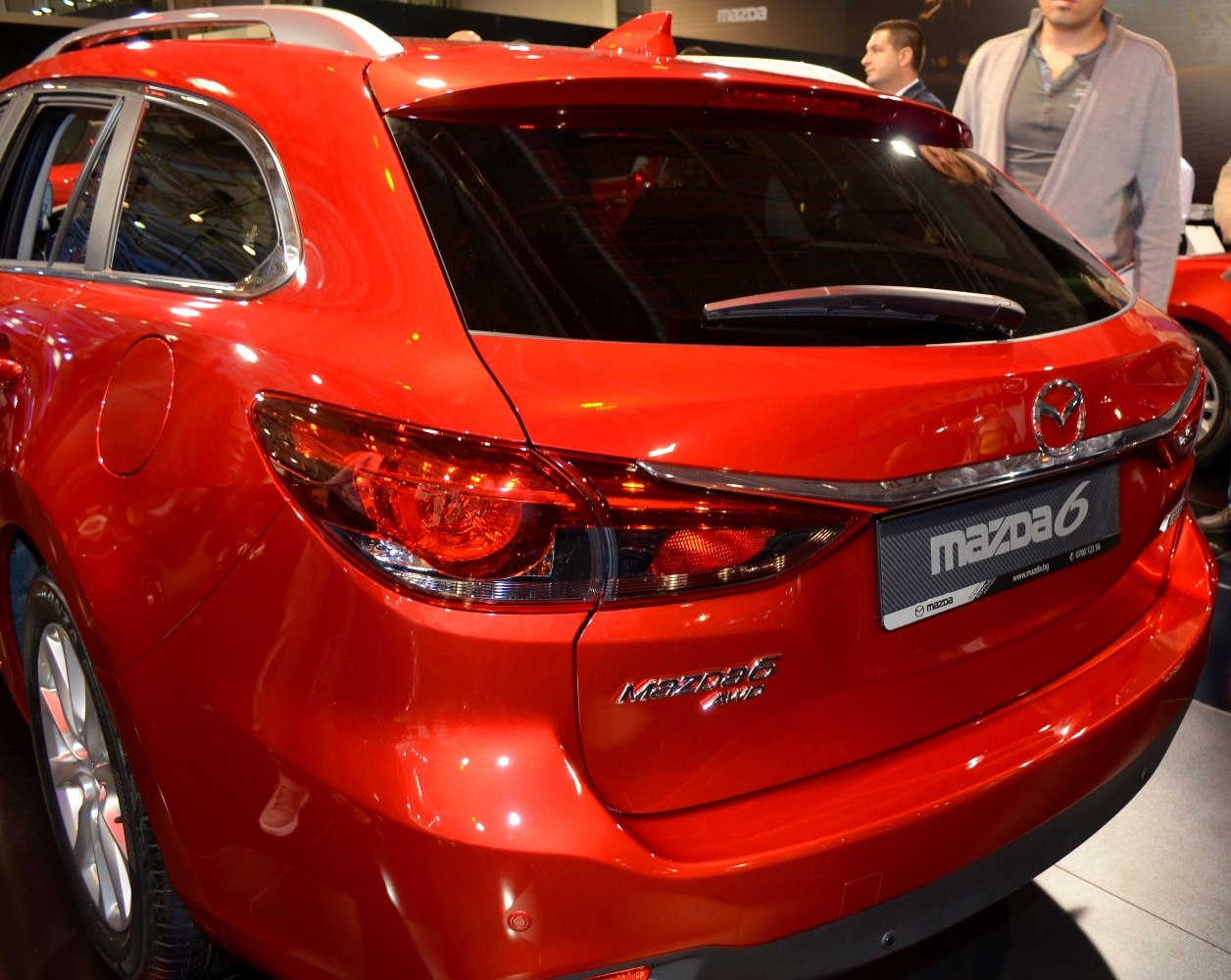 Rear view of red station wagon with distinct tail lights and rear window