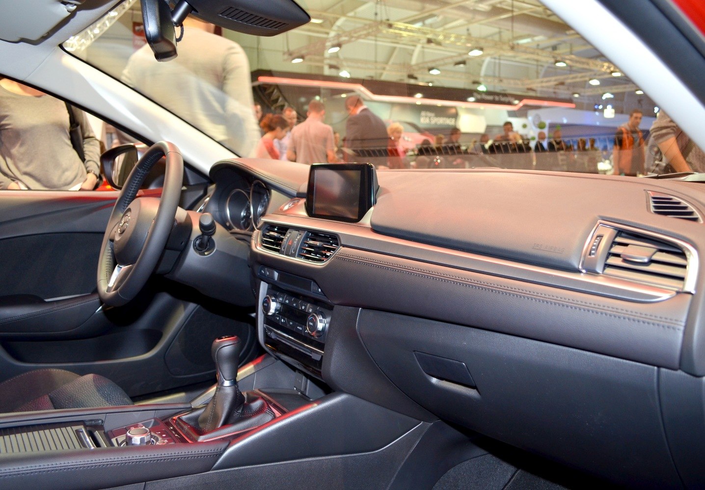 Car interior with dashboard, infotainment screen, and gear shift