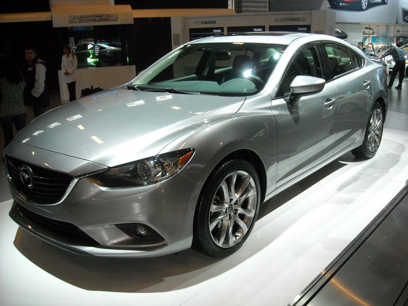 Sleek sedan front side with modern headlights and alloy wheels