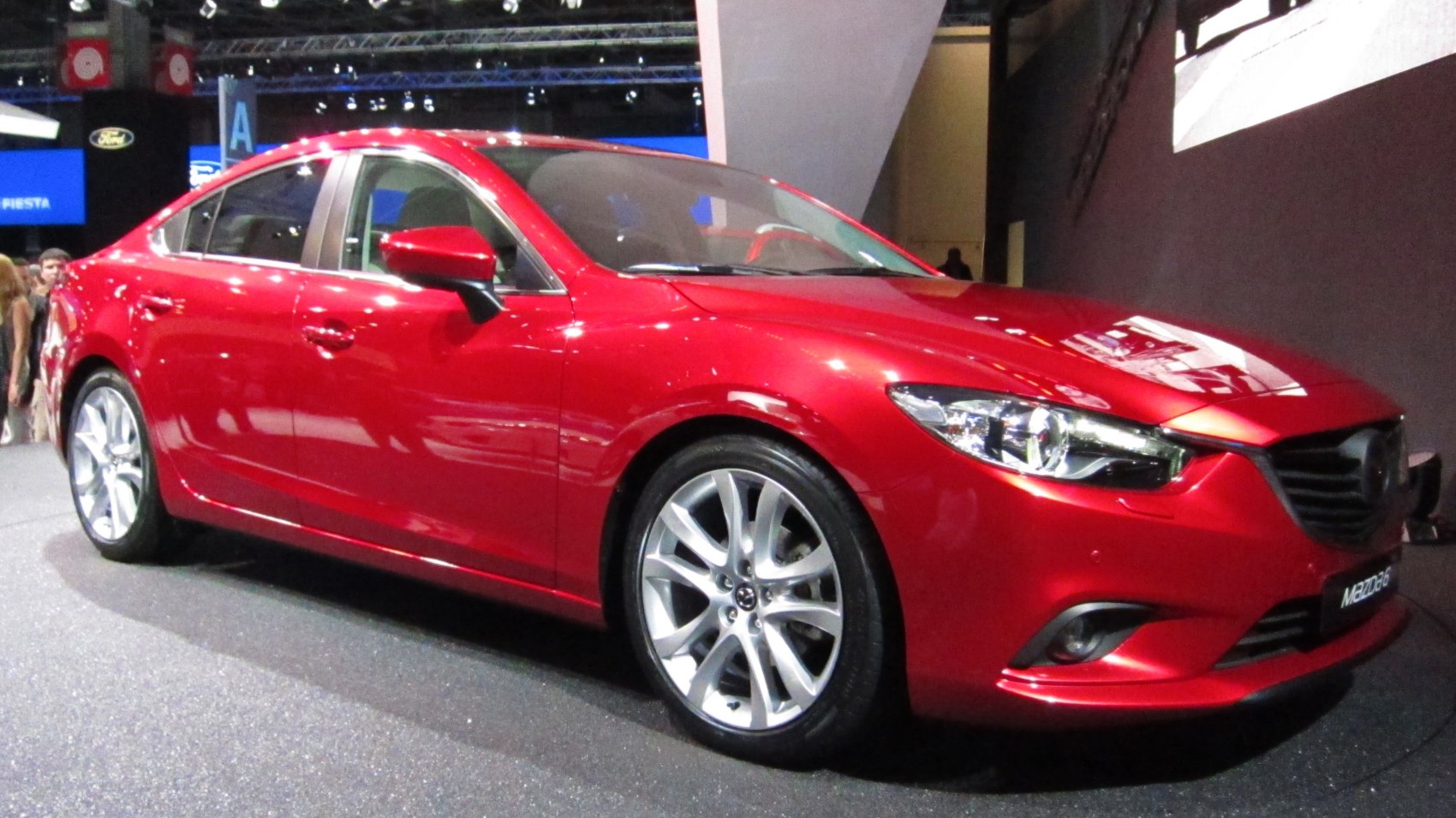 Red sedan with alloy wheels front side view