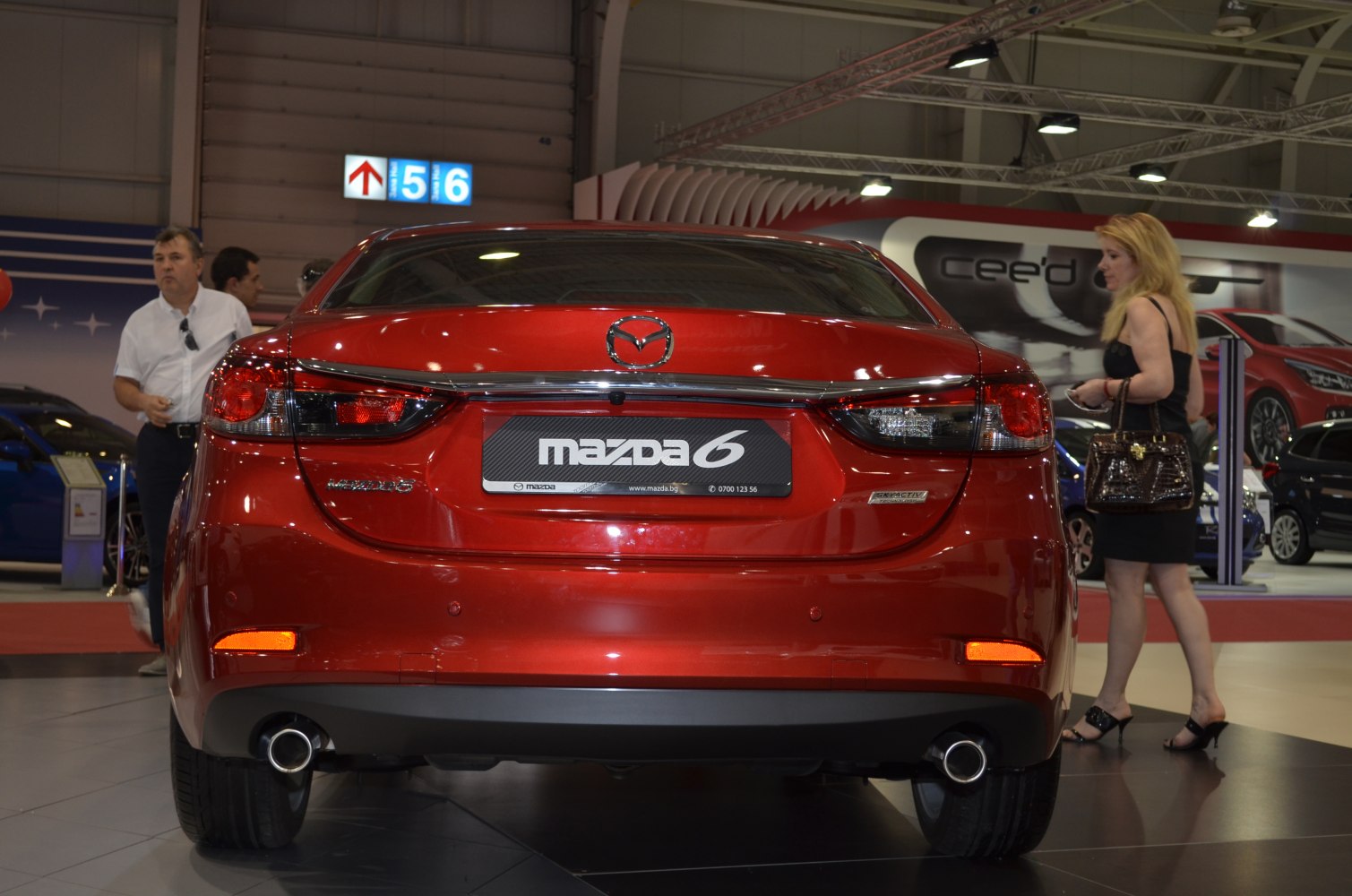 Red sedan rear with tail lights and dual exhaust