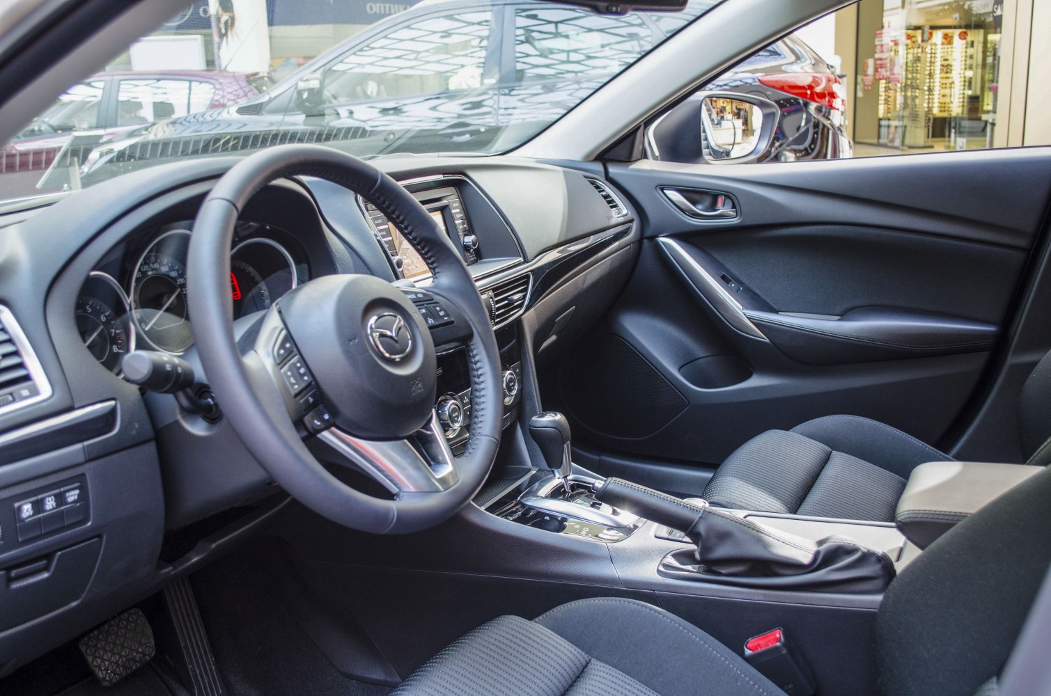 Interior dashboard, steering wheel, and center console with automatic gear shift
