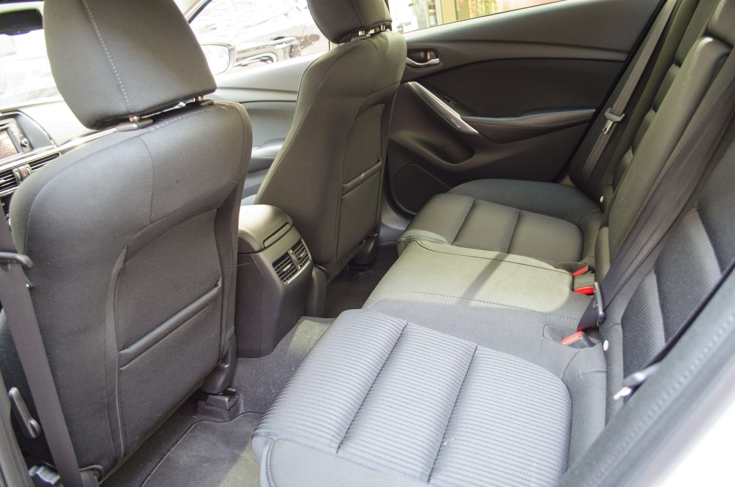 Rear passenger seating with fabric upholstery and rear air vents