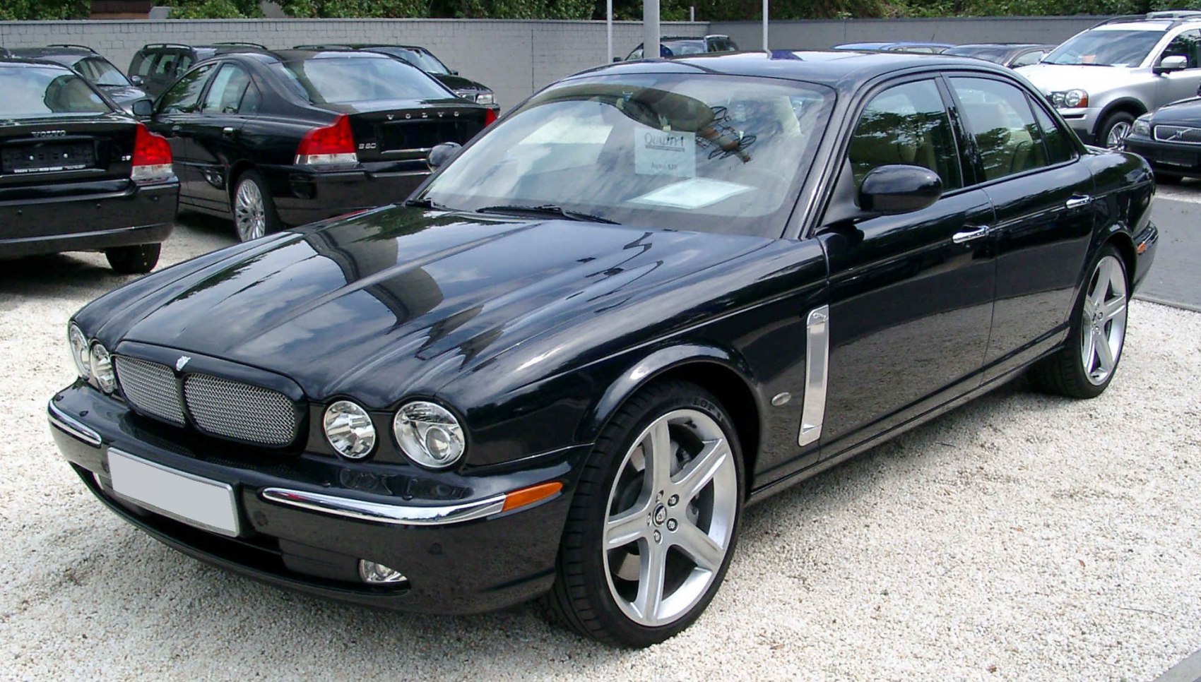 Luxury sedan with mesh grille and quad round headlights