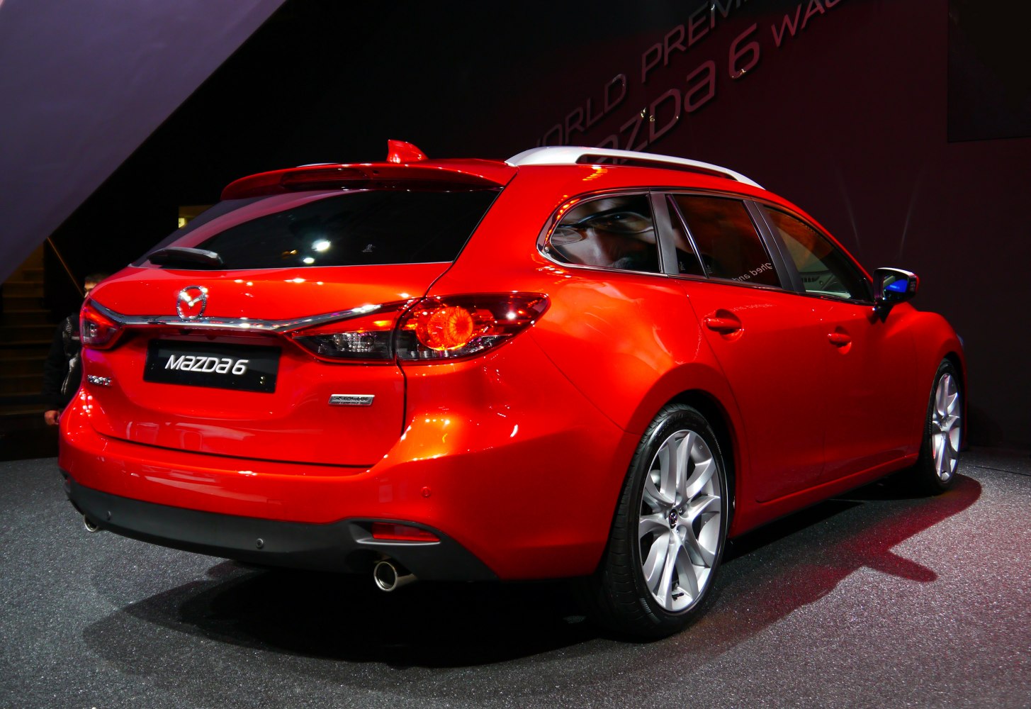 Rear of red station wagon with dual exhaust and roof rails