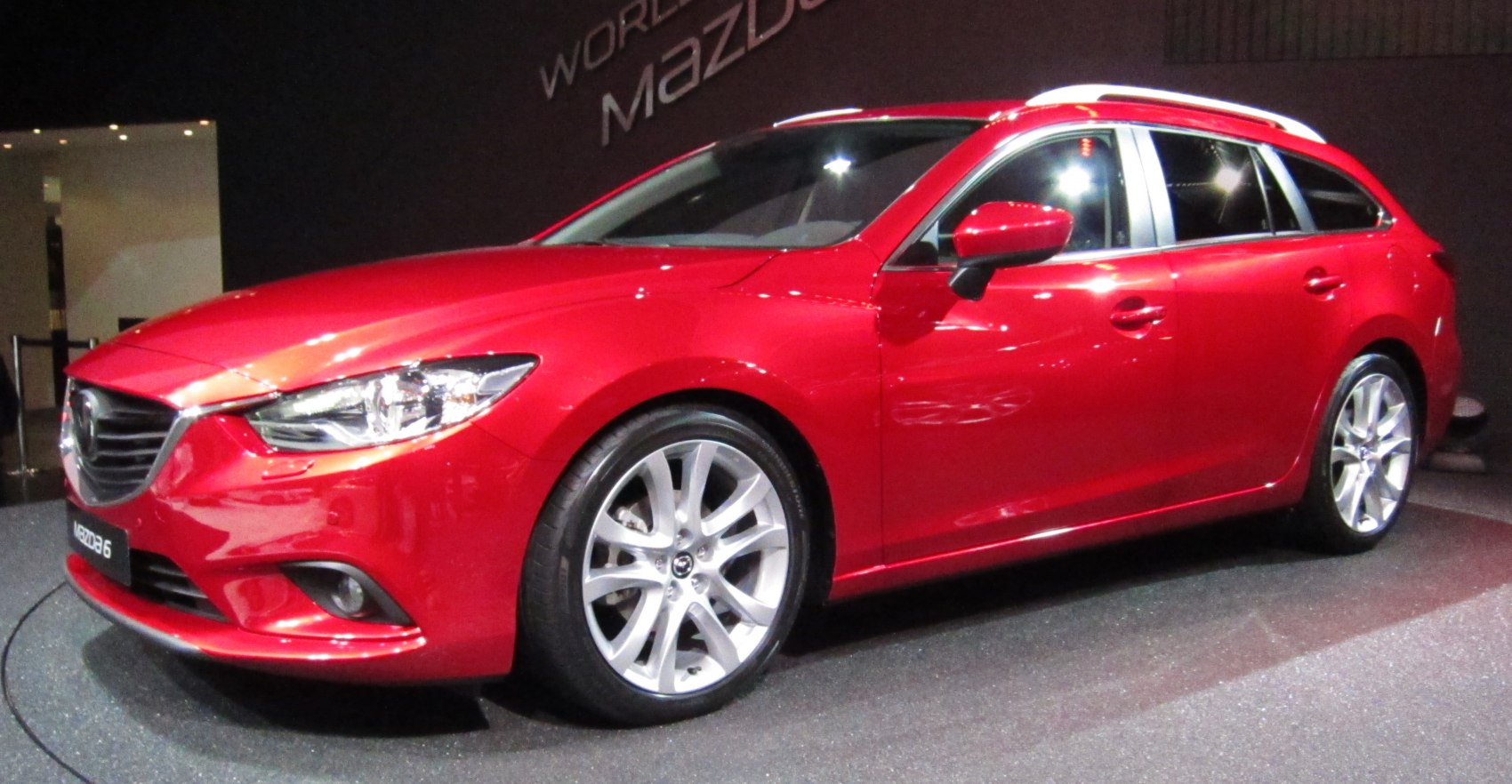 Red station wagon front side view with alloy wheels and roof rails