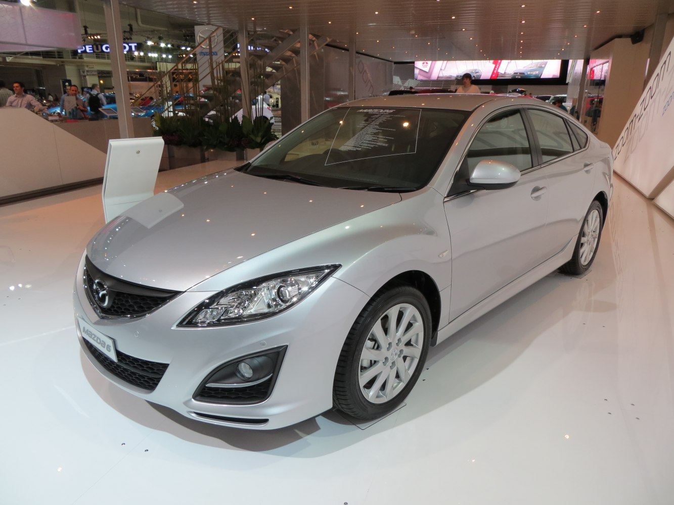 Front-side view of sedan with alloy wheels and fog lights