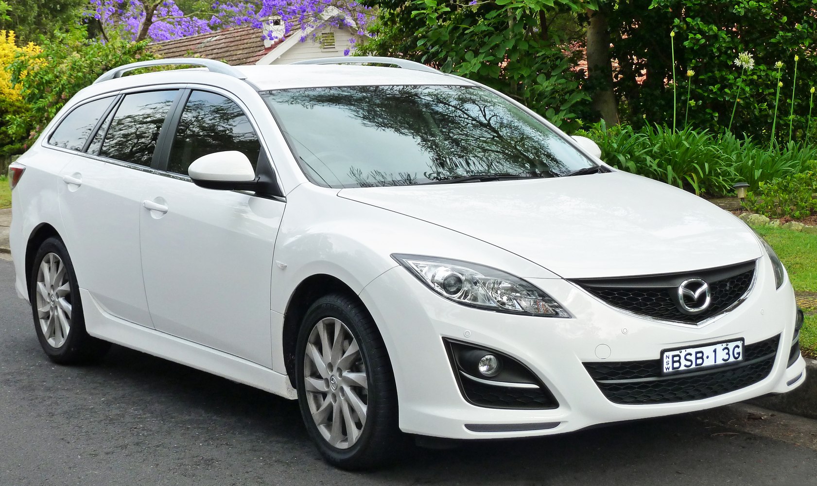 Front and side view of a station wagon with roof rails, alloy wheels, and sleek headlights