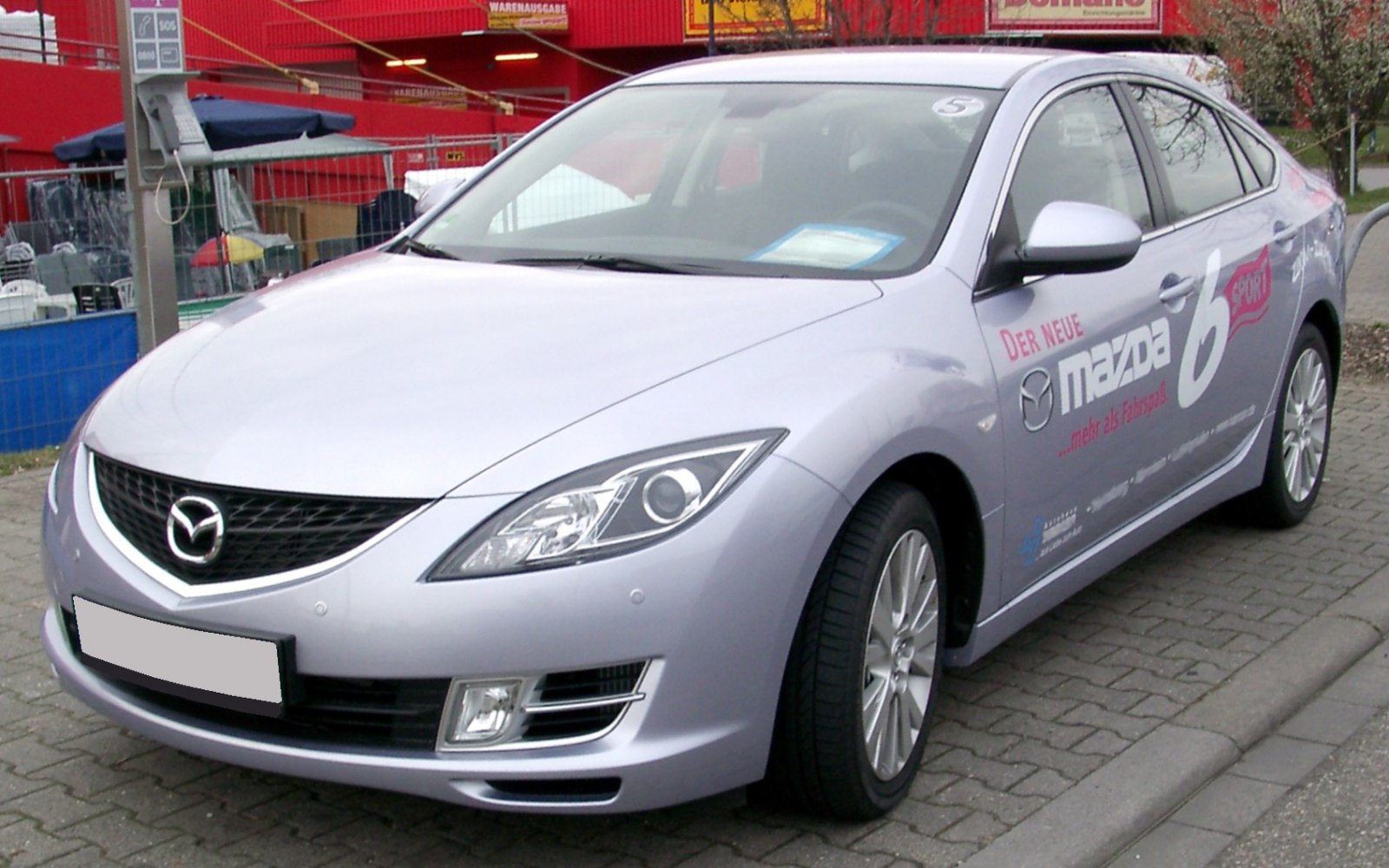 Modern mid-size sedan with angular headlights and prominent front grille