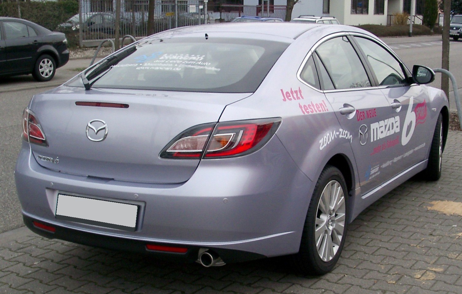 Distinctive rear sedan view with tail lights and dual exhaust
