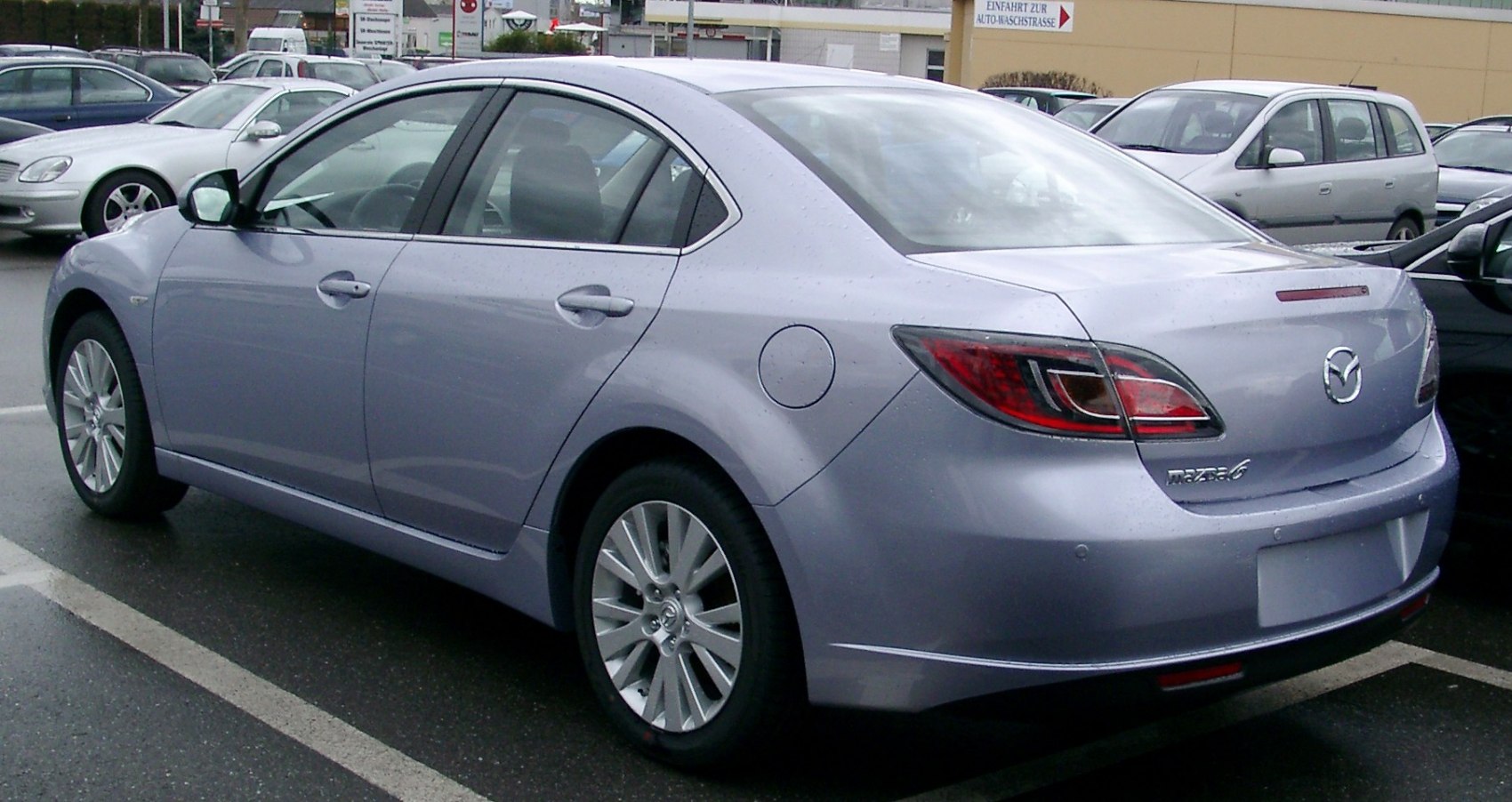Rear side view of a sedan with sharp taillights and smooth body lines