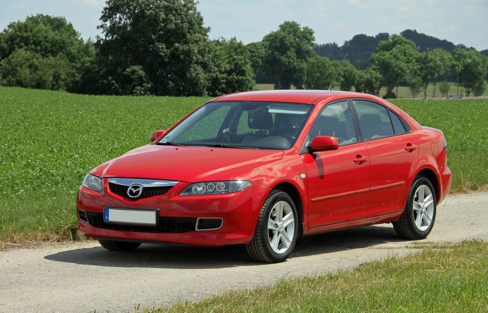 Front-side view of a red hatchback with alloy wheels