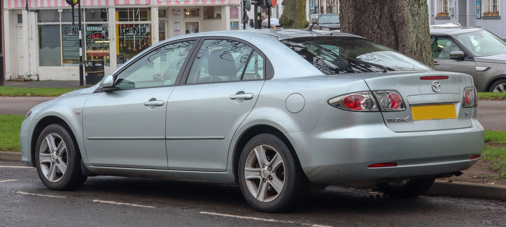 Silver hatchback showing rear and side view with alloy wheels