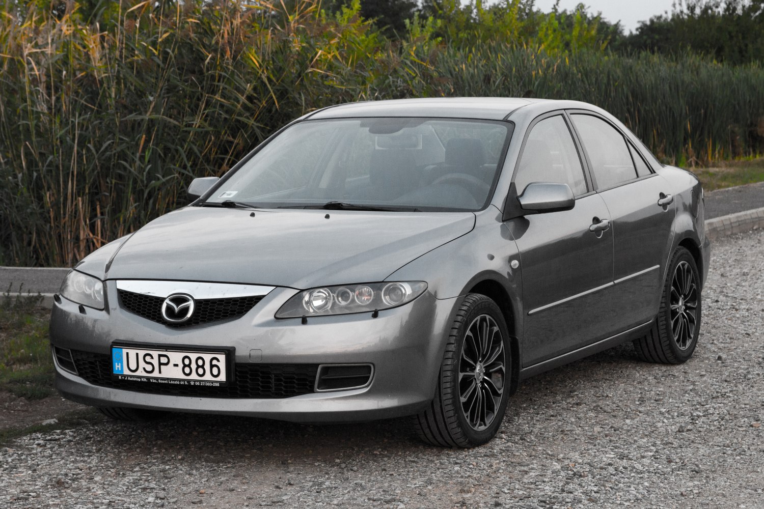 Front grille, alloy wheels, sleek headlights on a mid-size sedan
