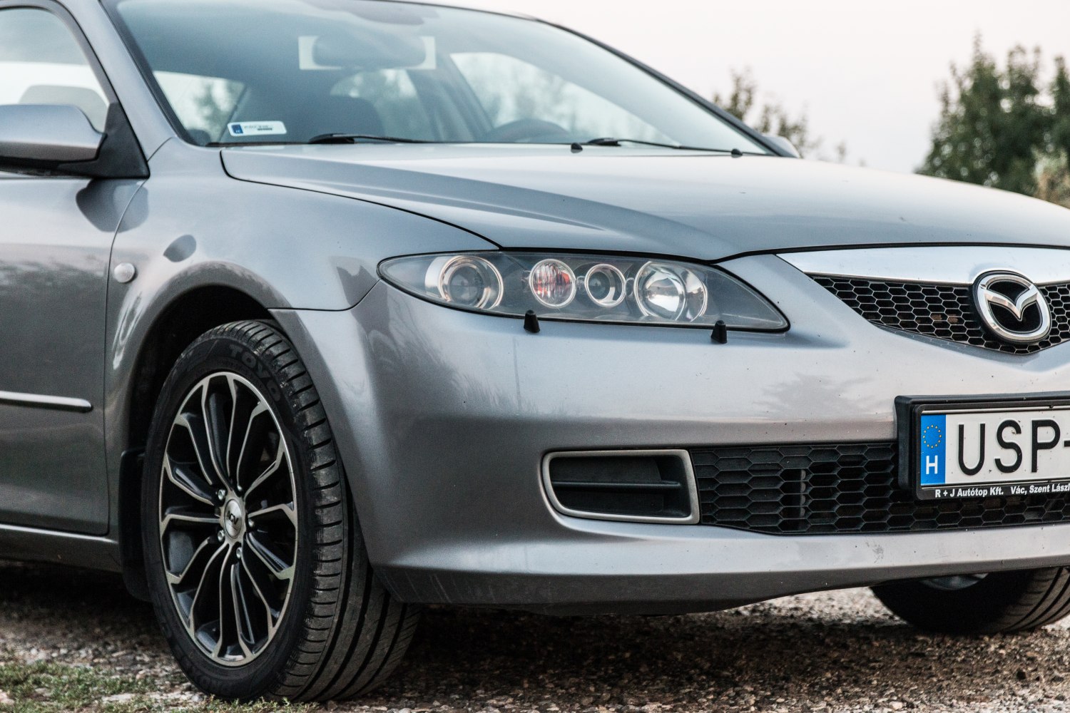 Front headlights and alloy wheel close-up on a sedan