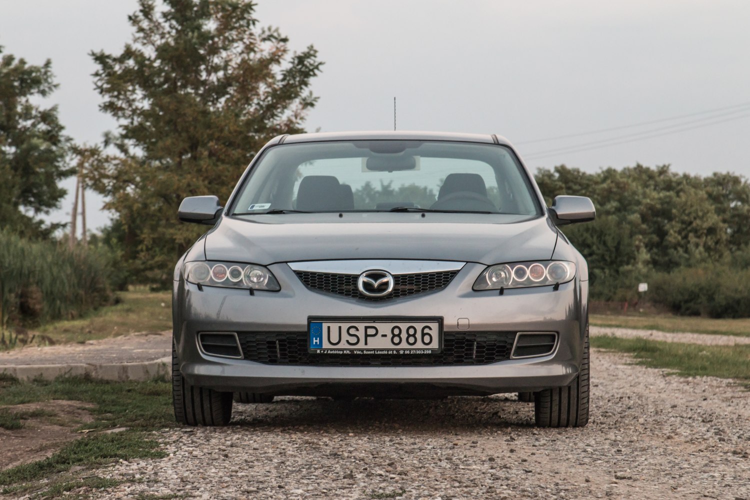 Front view of sedan with distinctive quad headlights and prominent grille