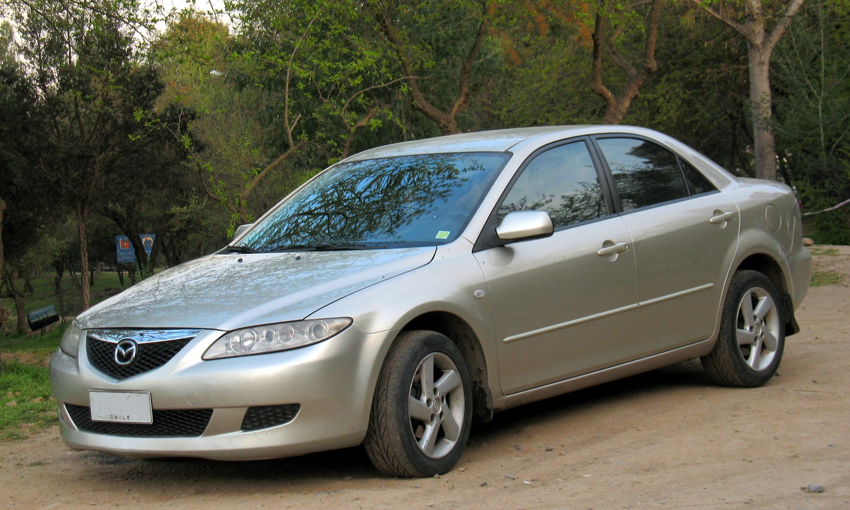 Front-side view of a sedan with sleek headlights and alloy wheels