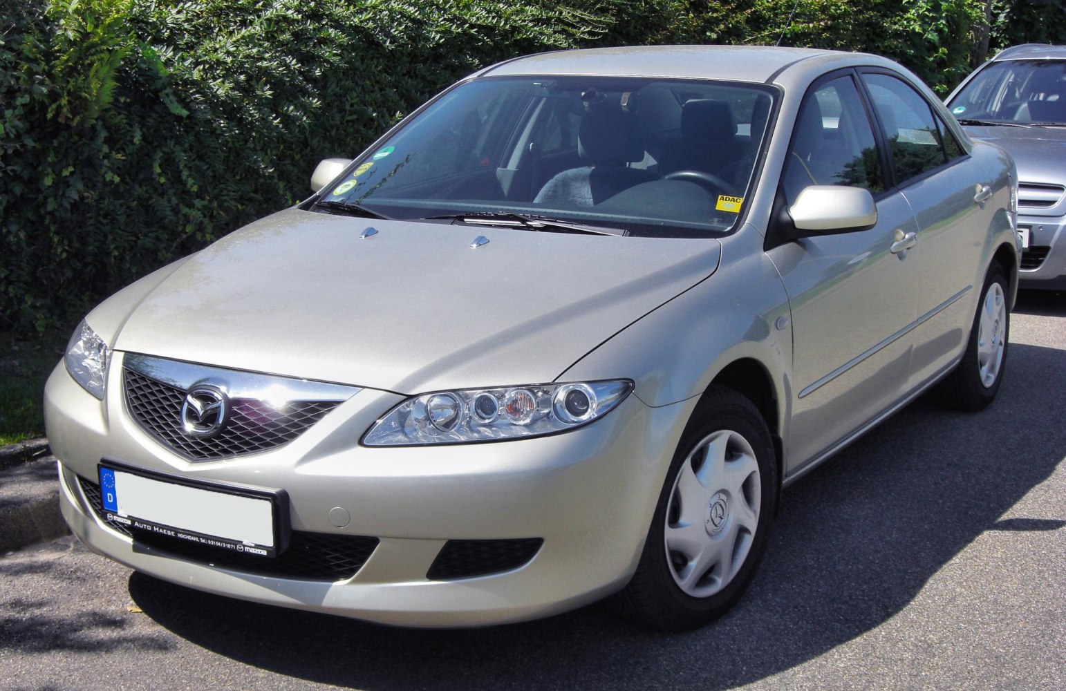 Front view of a sedan with distinctive grille and multi-element headlights
