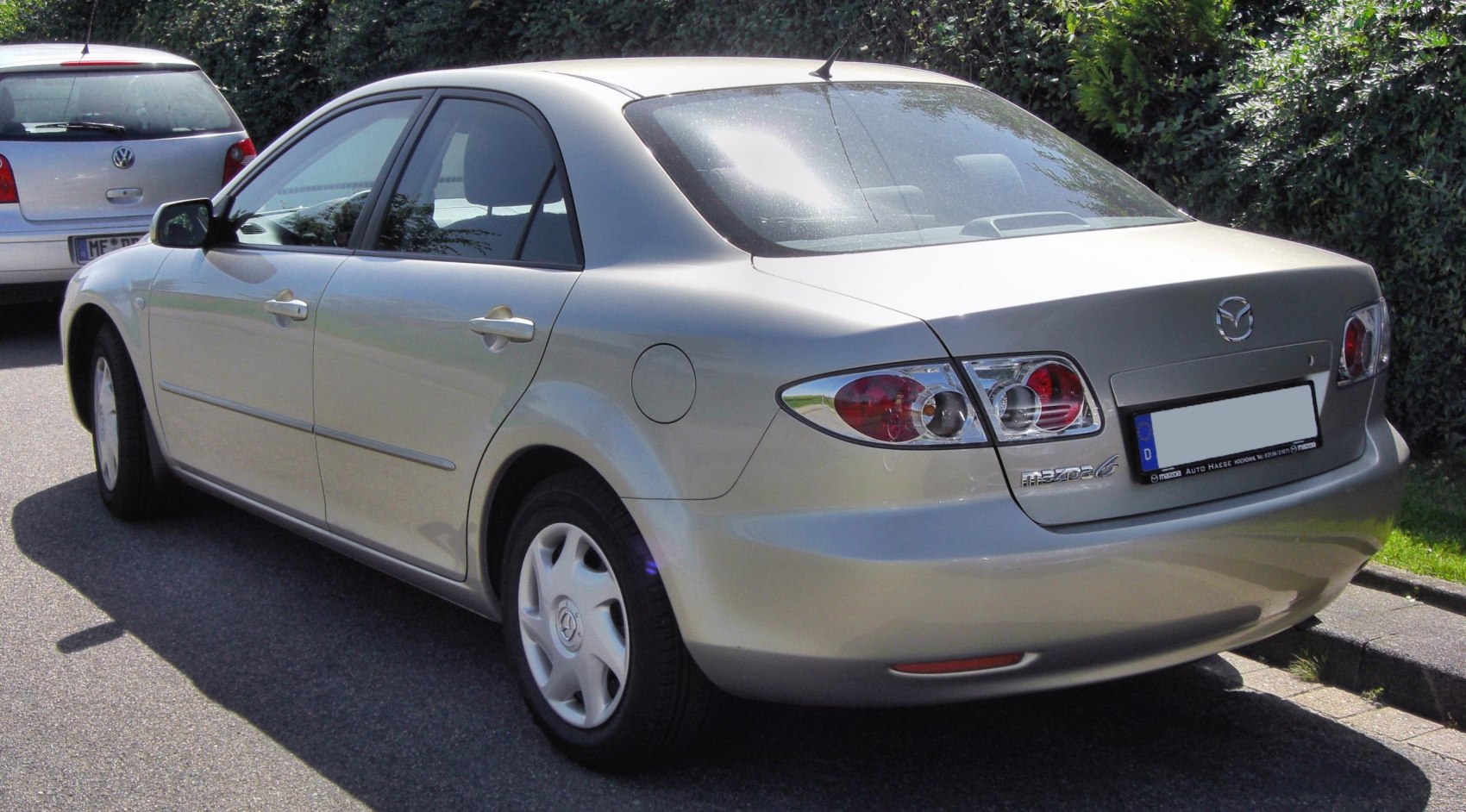Rear view of sedan with distinctive taillights and fuel cap on right side