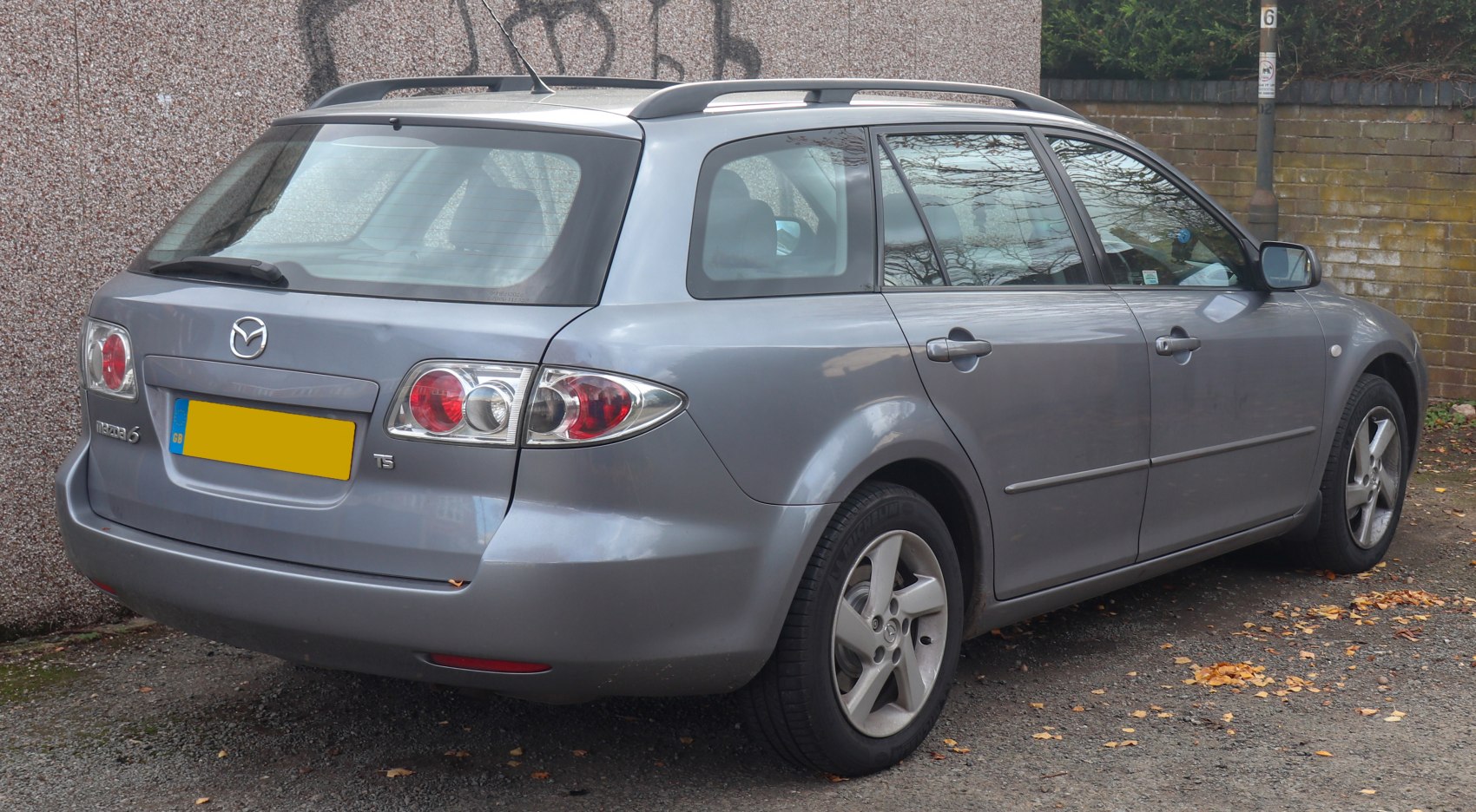 Rear view of a station wagon with roof rails and distinctive tail lights