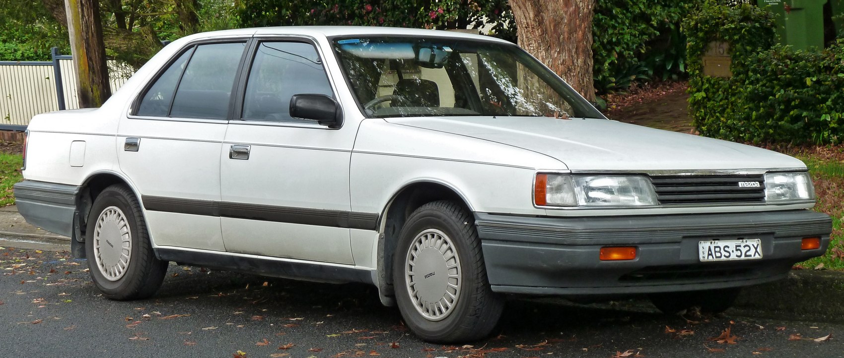 Sedan with rectangular headlights, gray bumpers, and styled hubcaps