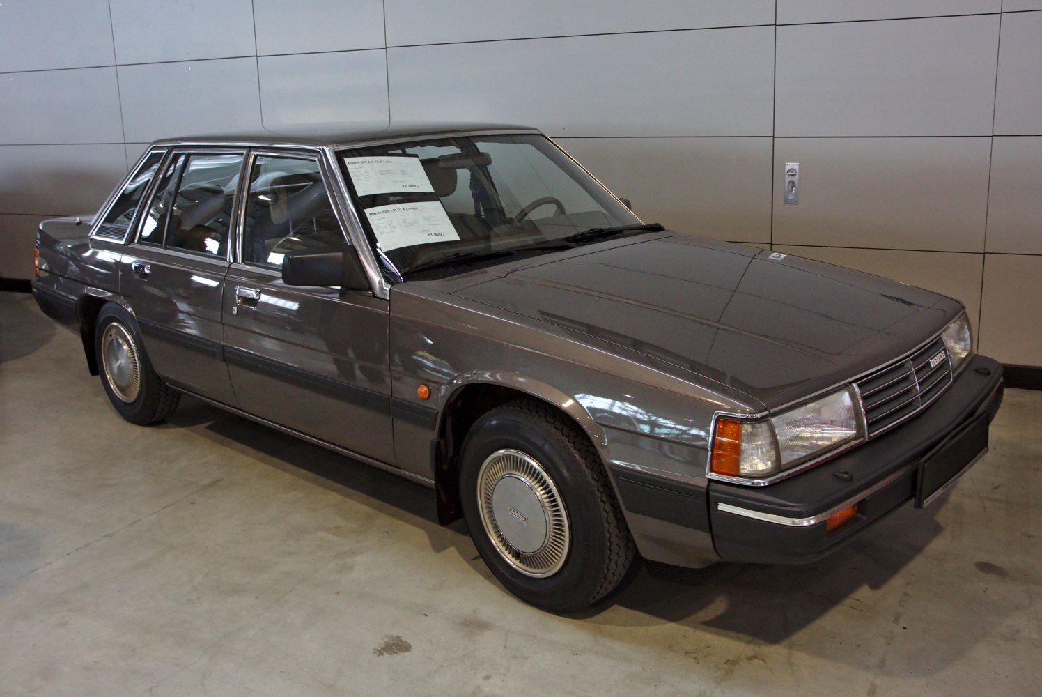 Boxy classic 4-door sedan with chrome accents and vintage hubcaps