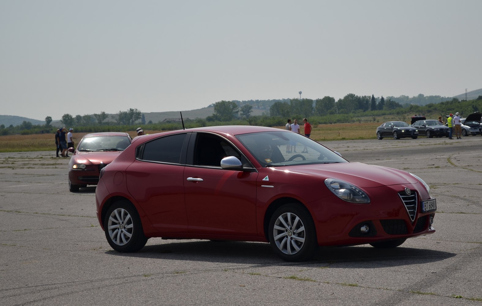 Red hatchback with smooth side profile and distinctive front design