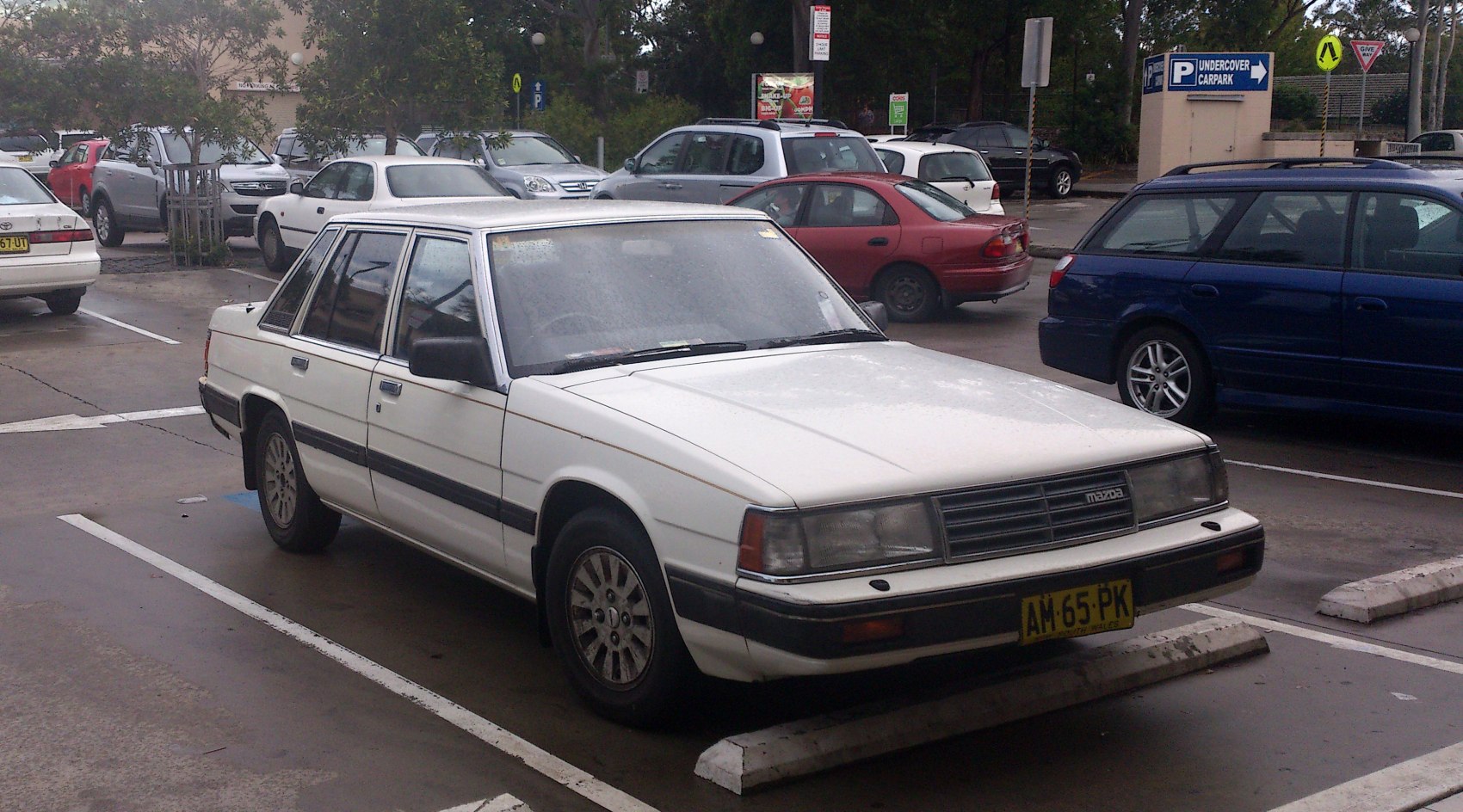 White classic sedan with rectangular headlights and vintage wheels