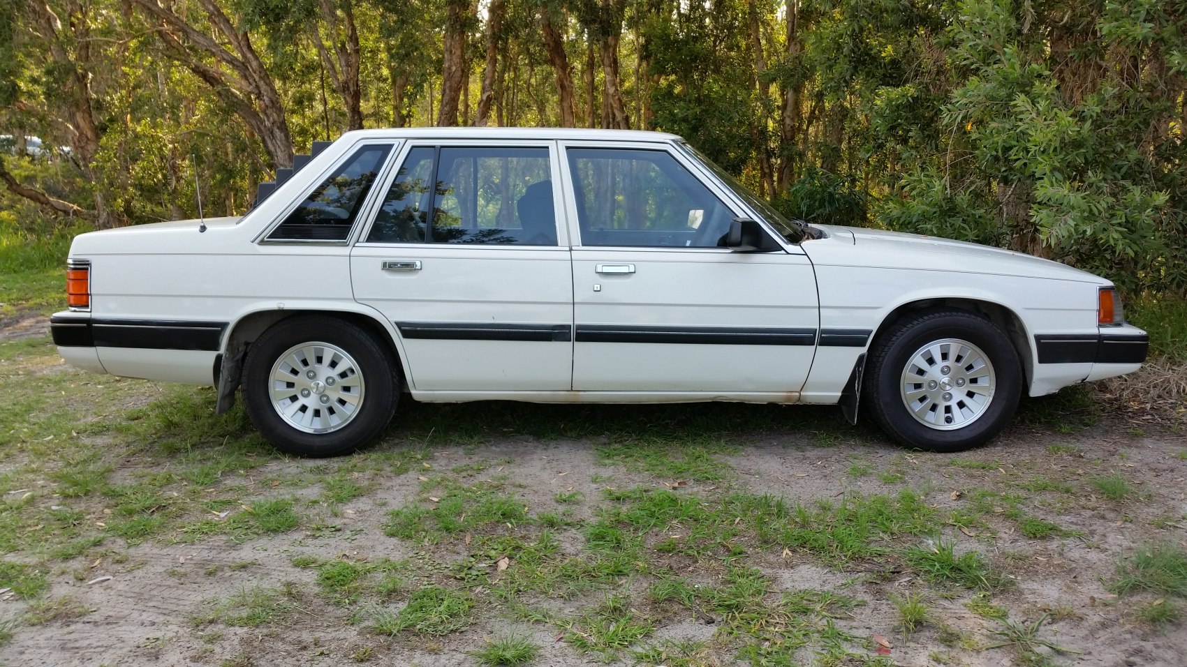 Classic vintage white four-door sedan side profile with distinct trim