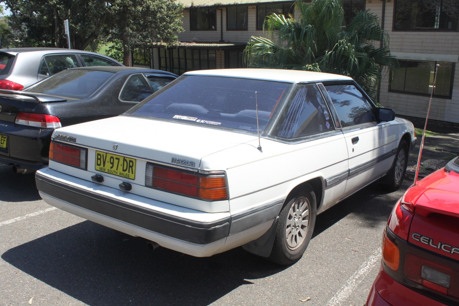 Rear view of 1980s coupe with classic tail lights and angular trunk design