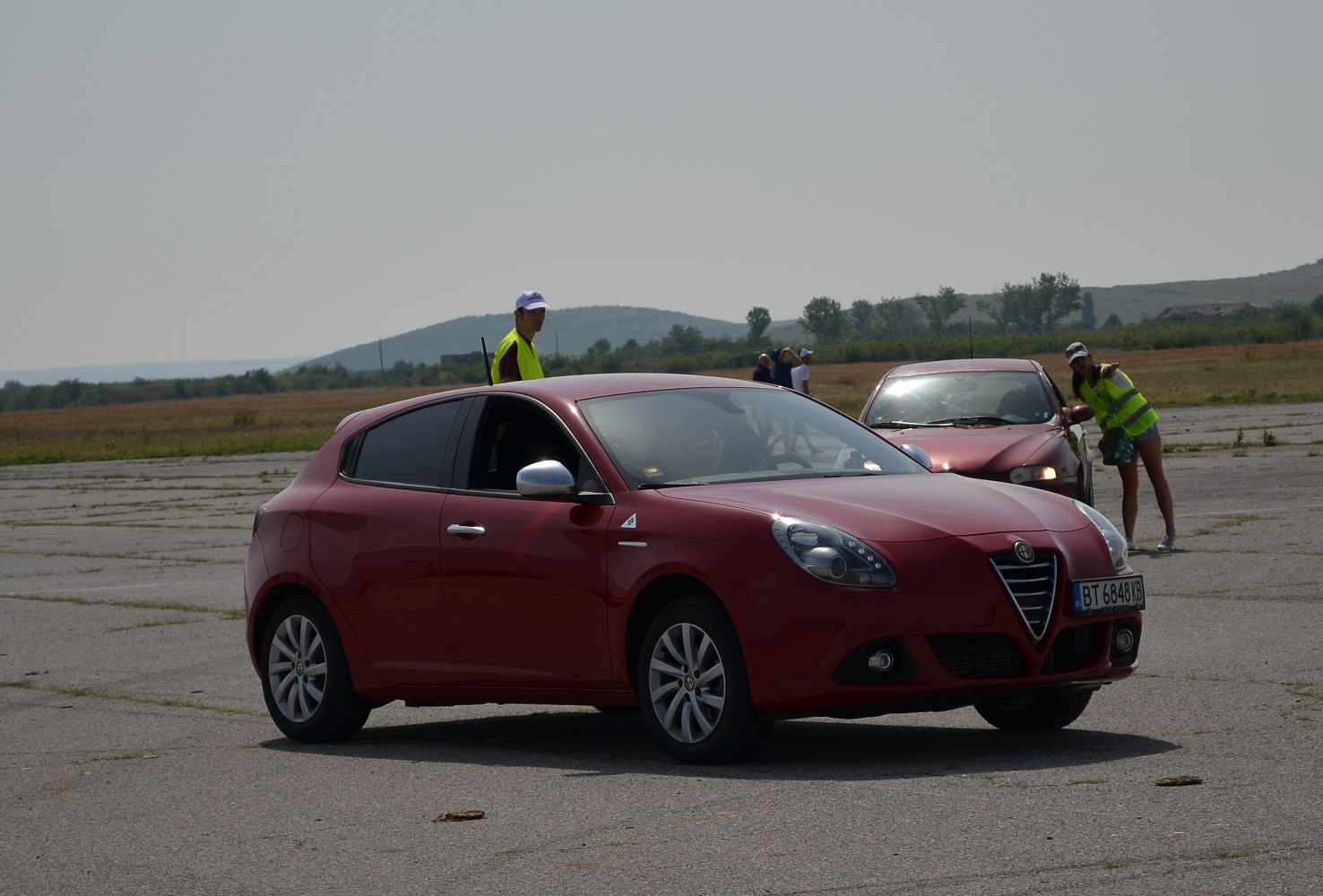 Red hatchback with distinct front grille and side profile