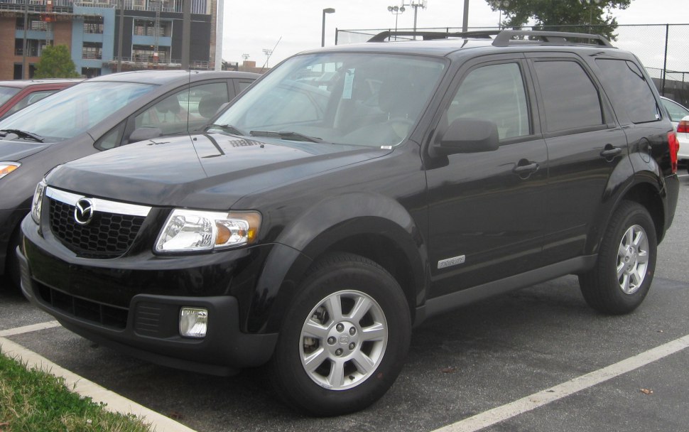 Black SUV front-side view with grille, alloy wheels, and roof rack