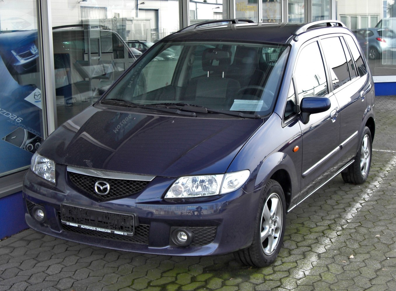 Front and side exterior view of compact multi-purpose vehicle with roof rails