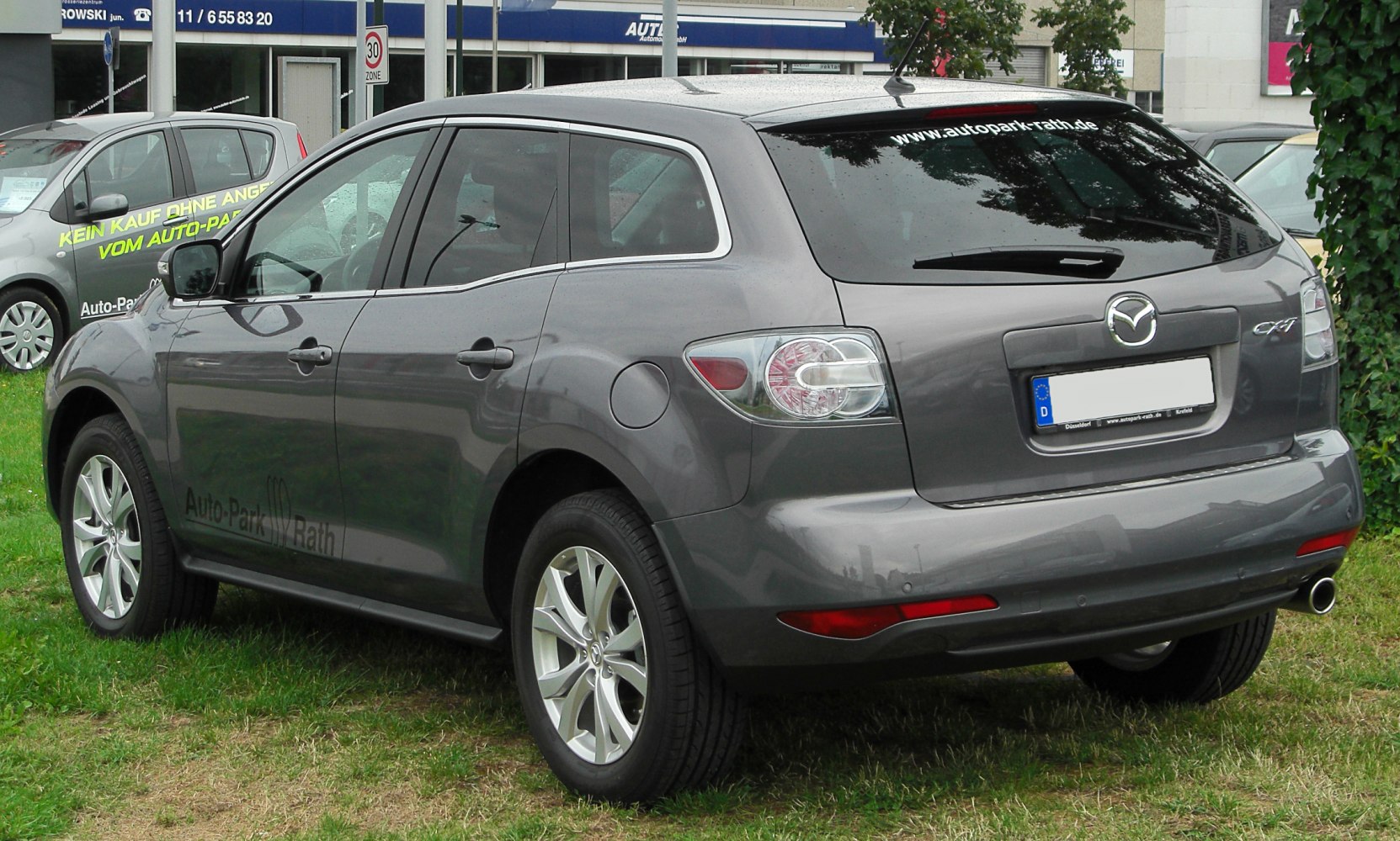 Rear side view of grey SUV with alloy wheels and taillights