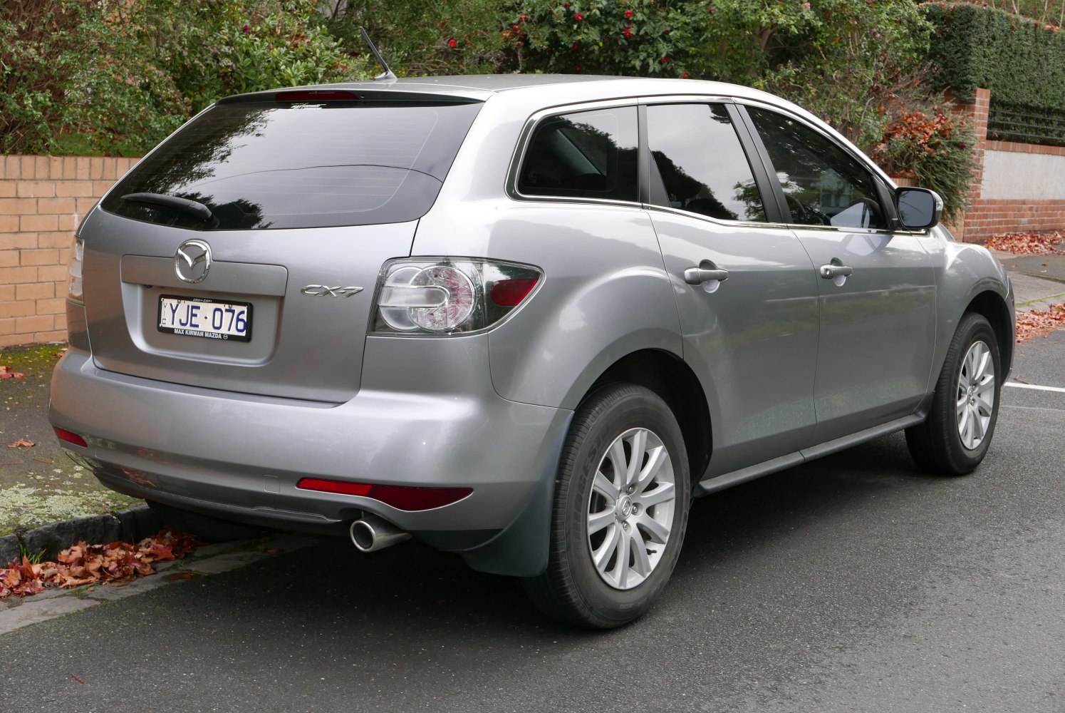 Silver SUV rear-side view with tail lights and alloy wheels