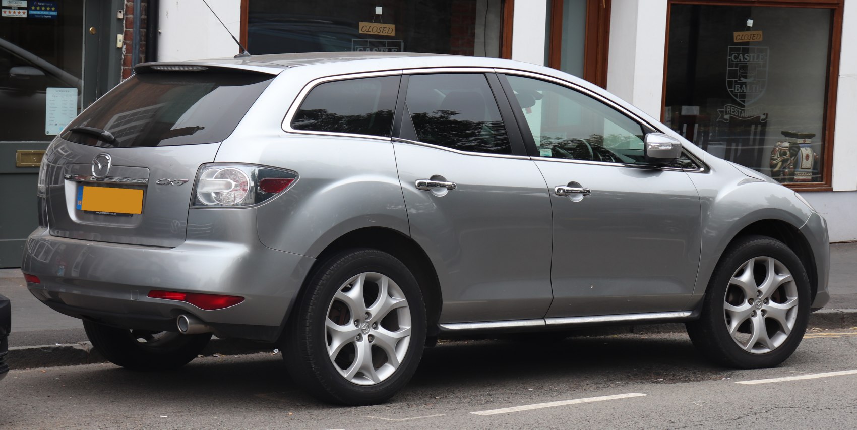 Silver SUV rear side profile with distinctive tail lights and alloy wheels
