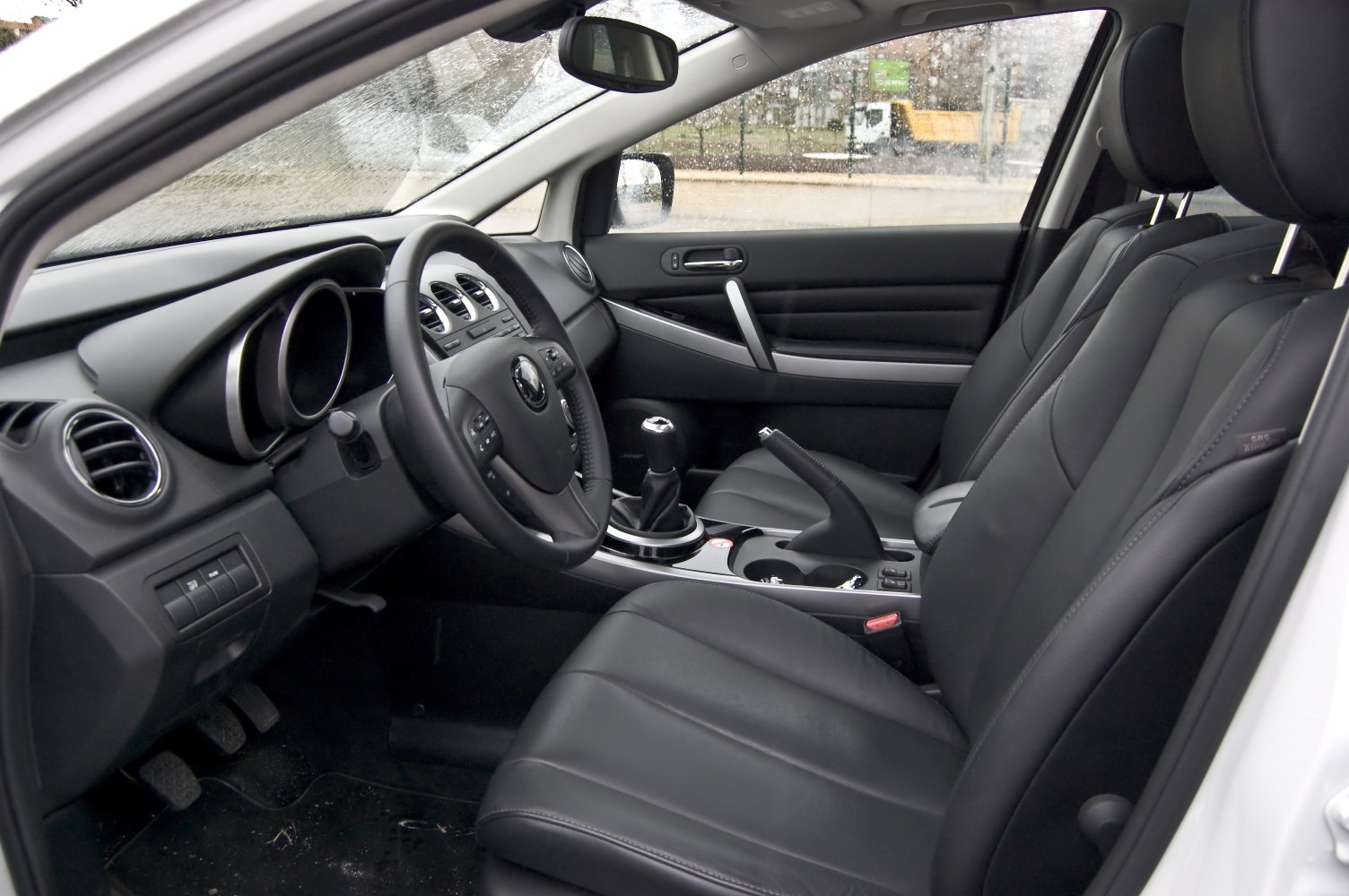 Leather seats and manual gearstick in modern car interior