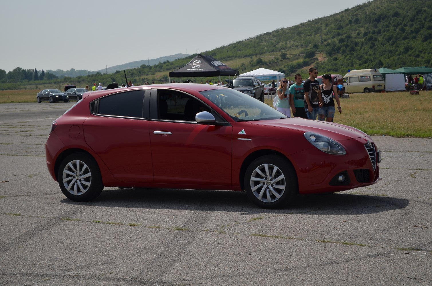 Side profile of a sporty hatchback with alloy wheels