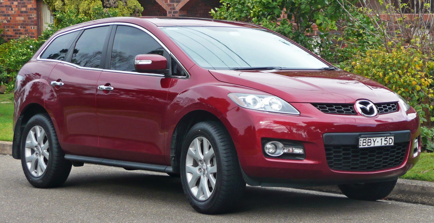 Front side view of compact SUV with alloy wheels and tinted windows