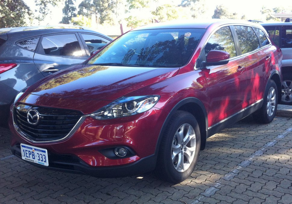 Front-side view of red SUV with distinct grille and headlights