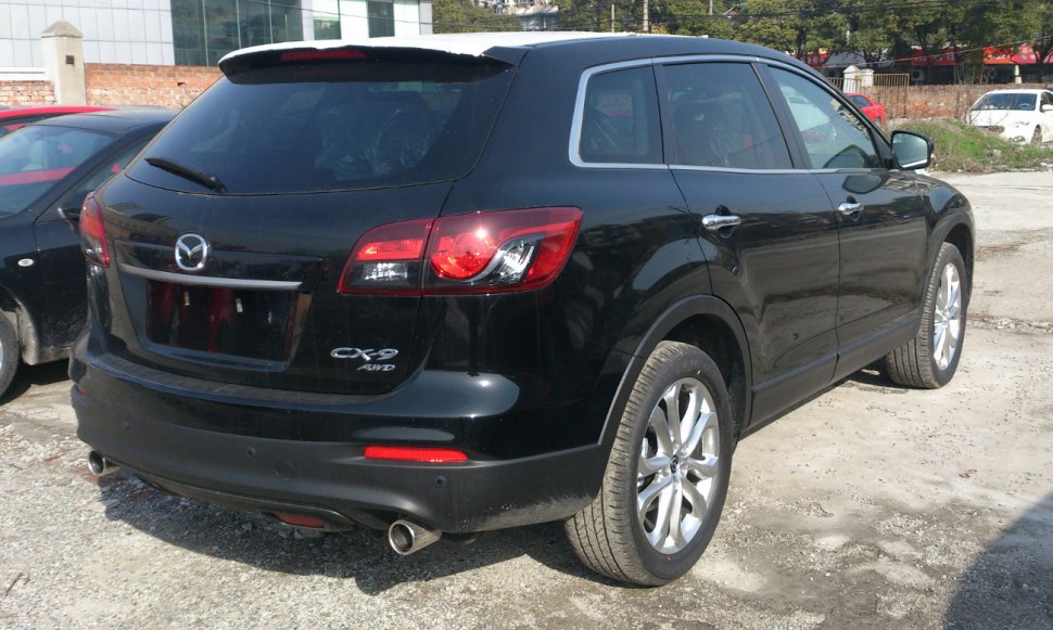 Rear view of black SUV with dual exhaust and distinctive taillights