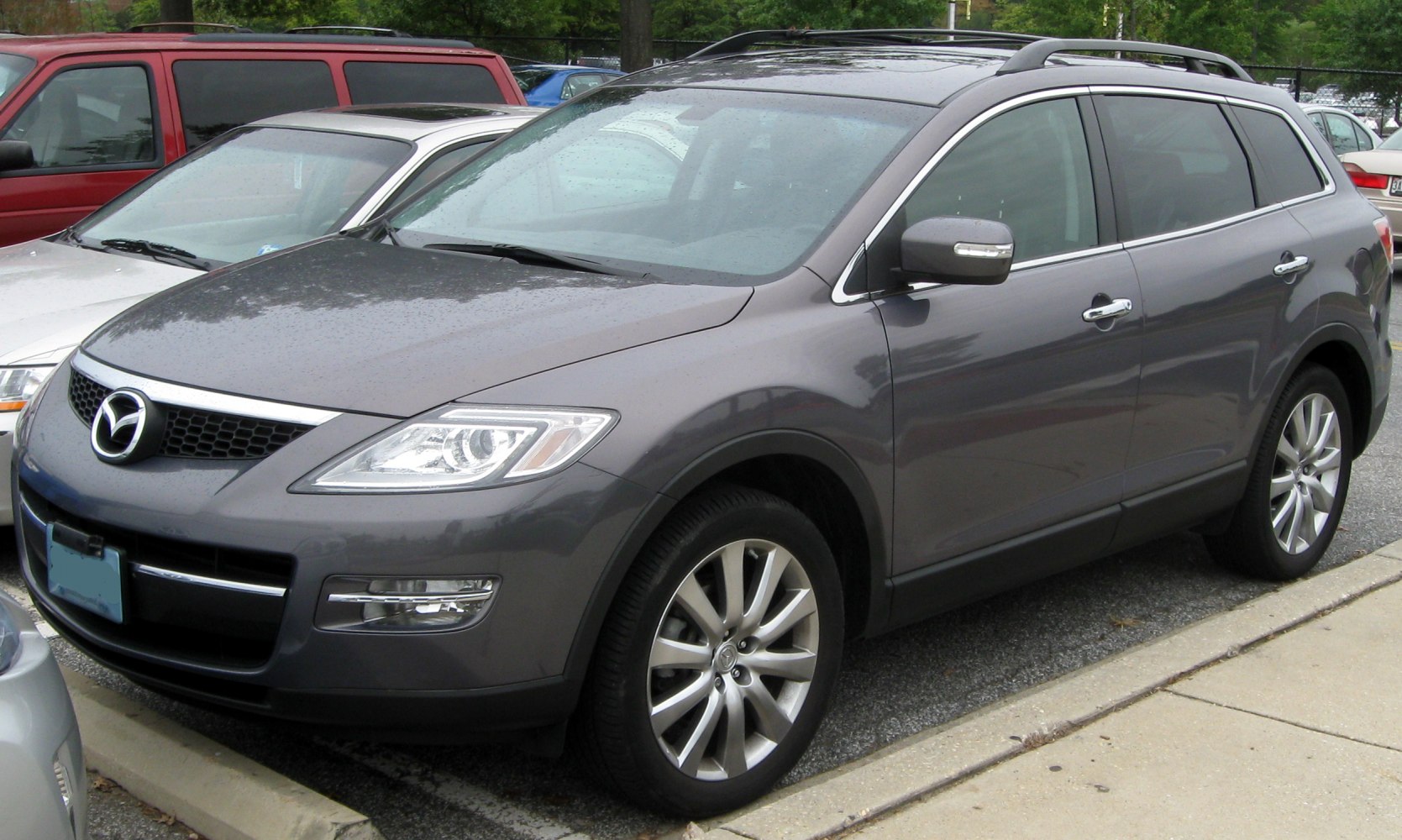 Front-side view of a gray SUV with distinct headlights and alloy wheels