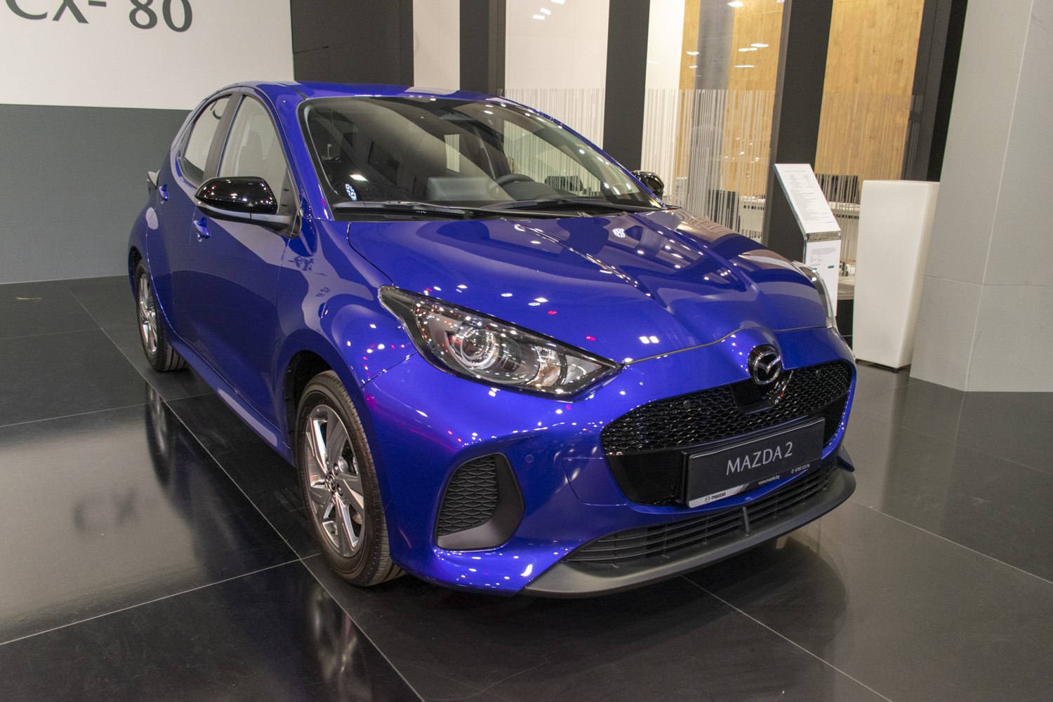Blue hatchback with LED headlights and honeycomb mesh grille