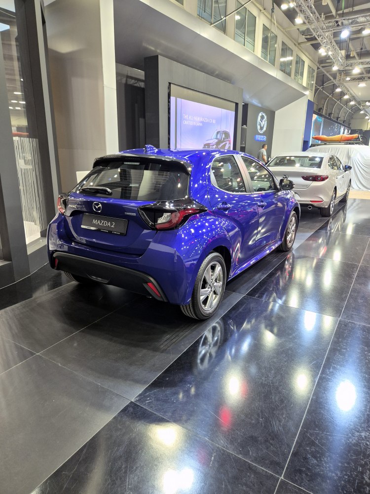 Rear and side view of a blue compact hatchback