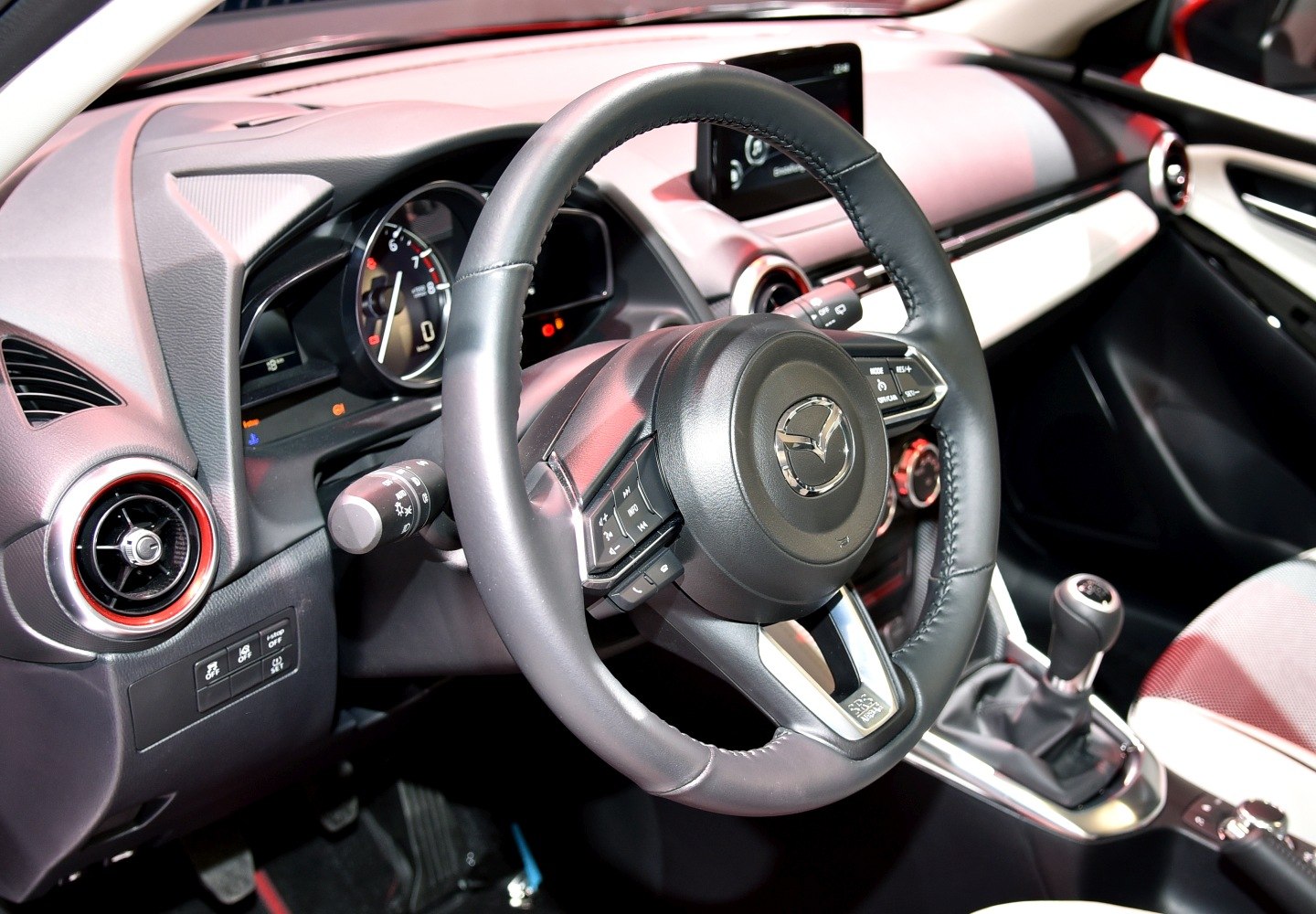 Steering wheel with controls and manual gearshift in car interior