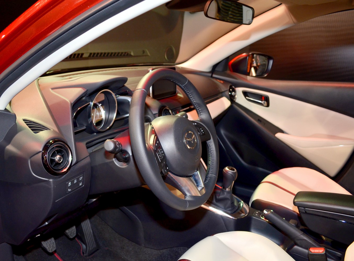 Leather steering wheel and manual gear shift in car interior
