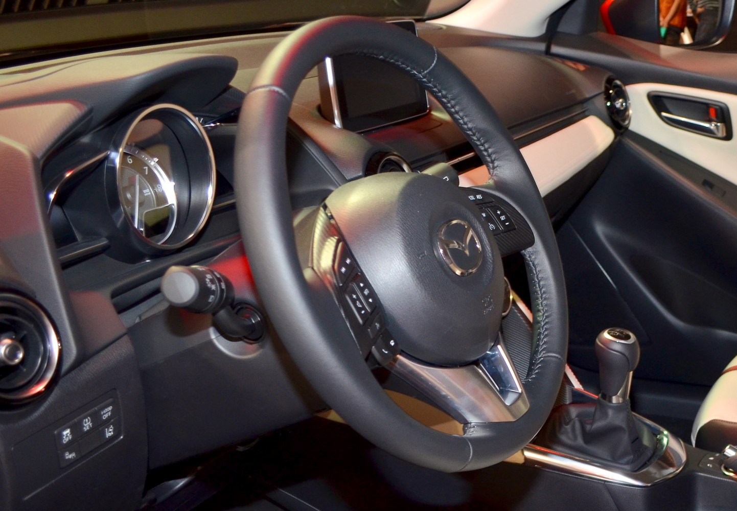 Interior view showing dashboard, steering wheel, and manual gear lever