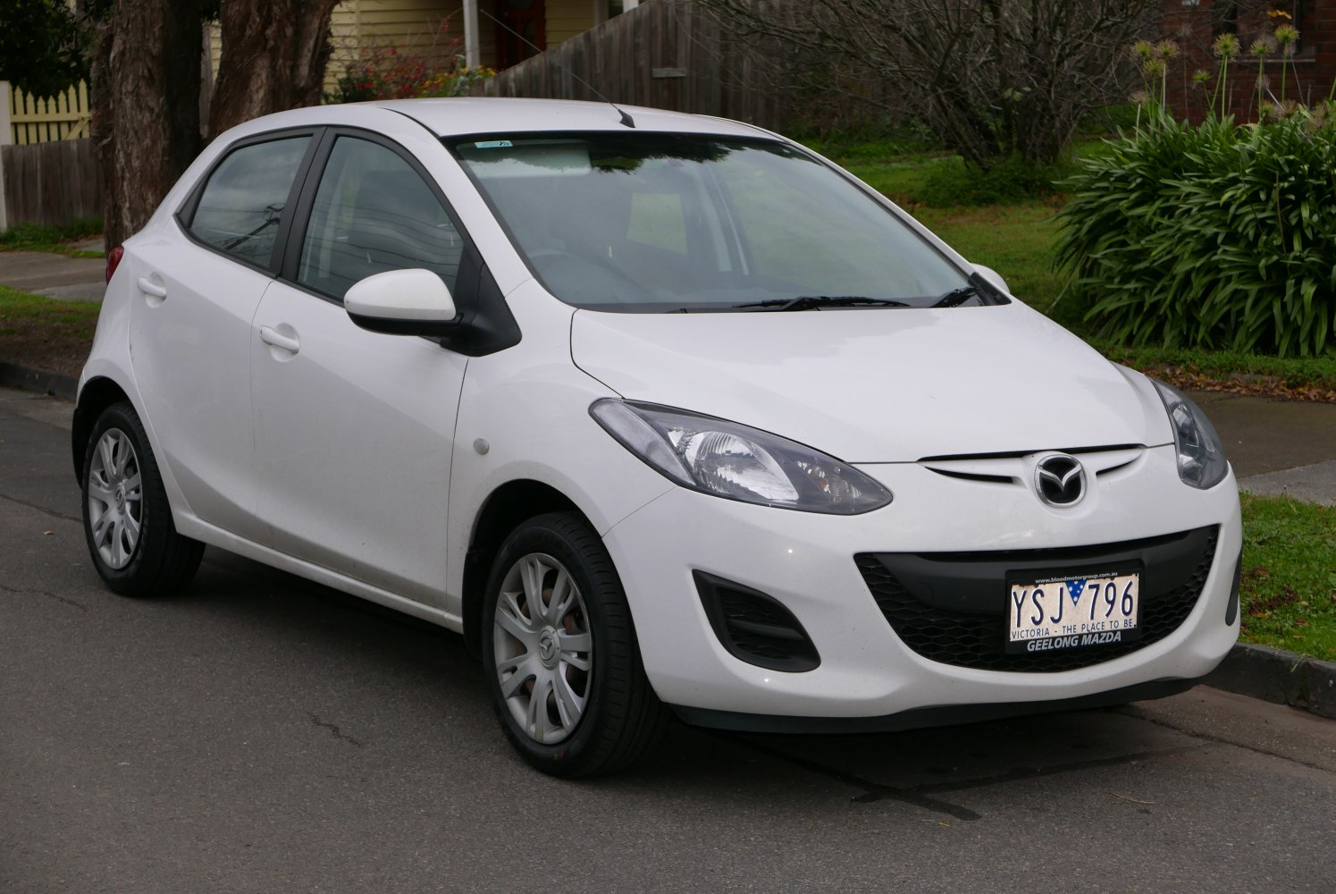 Compact white five-door hatchback with distinct headlights and aerodynamic front