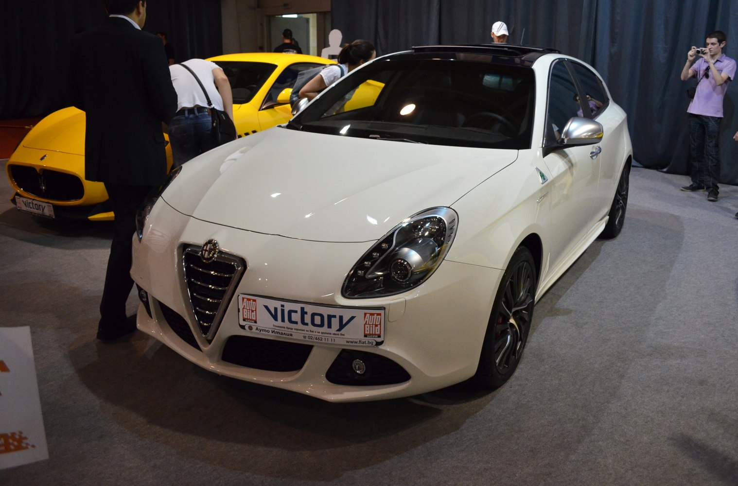 White hatchback with iconic grille and modern headlights