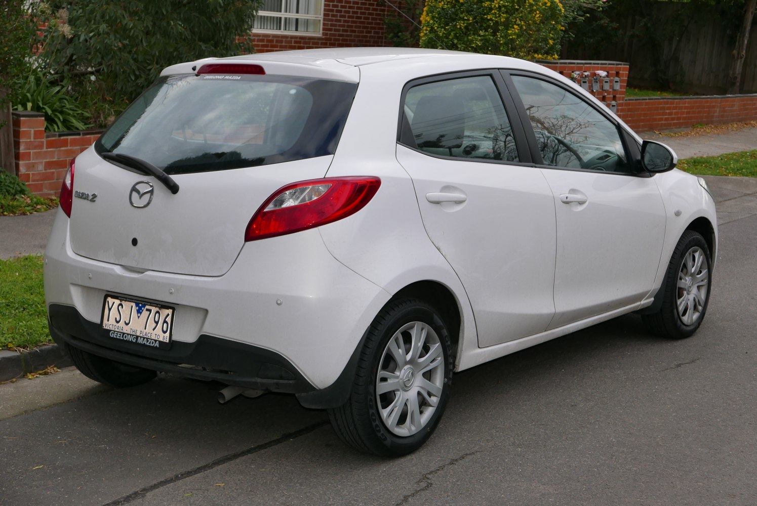 Rear and side view of a white five-door hatchback with distinctive rear lights